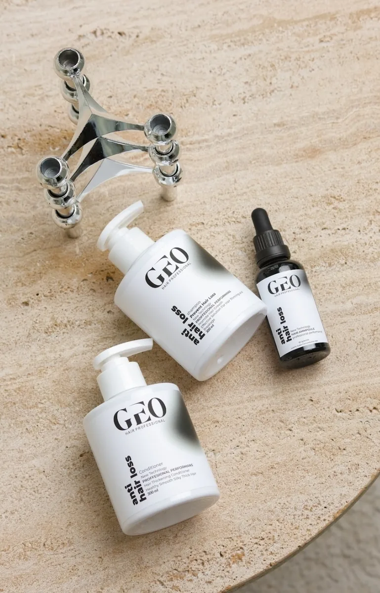 GEO Anti Hair Loss Shampoo and Conditioner (normal & dry hair) with the Anti Hair Loss Ampoule on a travertine table